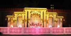 an elaborately decorated stage with pink lighting