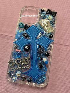 a phone case with buttons and other things on the back, sitting on a pink surface