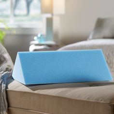 a blue block sitting on top of a couch