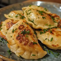 some dumplings are sitting on a plate with parsley sprinkled around them