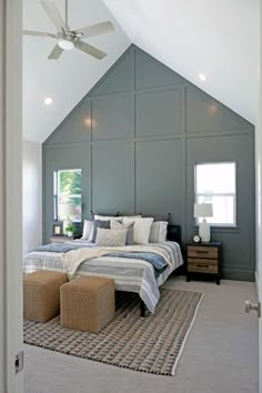 a large bed sitting under a ceiling fan in a bedroom