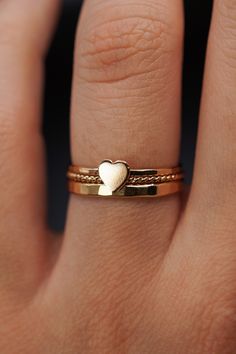 The small heart adds a lovely detail to this lightly hammered stacking ring. Each ring is handmade to order in your ring size for a perfectly customized fit. This ring makes for the perfect anniversary, birthday or valentine's day gift for your special somebody! The band measures approximately 1mm in width and features a lightly hammered finish. The Heart detail measures approximately 5mm in width. This listing is for ONE SINGLE Heart Ring in 14K GOLD FILL metal. This ring is a great alternative Dainty Rings Gold, Dainty Rings, Thick Ring, Hammered Band, Hammered Rings, Twist Ring, Gold Ring Stack, Small Heart, Favorite Rings