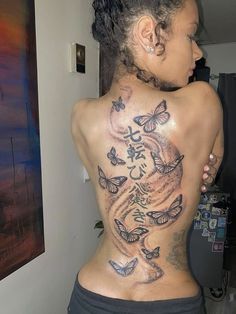 a woman with tattoos on her back