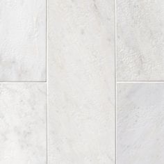 white marble tiles are arranged in four rows