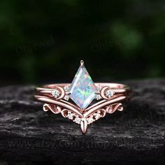 a ring with an opal stone and diamonds on it