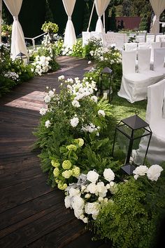 an outdoor wedding setup with white and green flowers