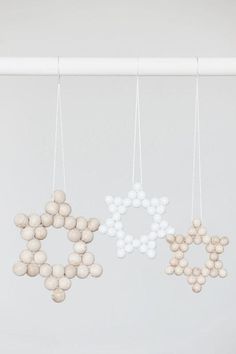 three white and beige ornaments hanging from the ceiling