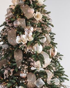 a christmas tree decorated with gold and silver ornaments