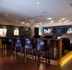 a sports bar with chairs and televisions on the wall