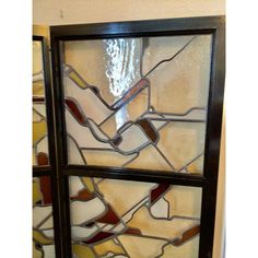 a stained glass window in the corner of a room