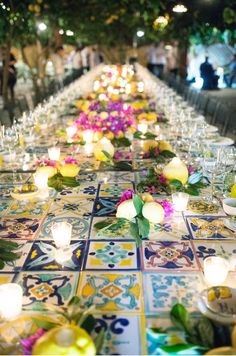 the long table is decorated with flowers and candles