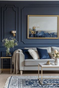 a living room with blue walls and white furniture