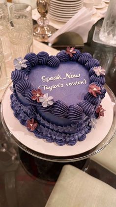 a cake with purple frosting and flowers on it that says speak now taylor's vernon