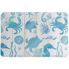 a blue and white bath mat with sea animals on it