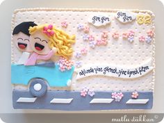 a birthday cake decorated with a girl driving a car