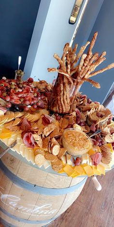 a wooden barrel filled with lots of different types of snacks on top of each other