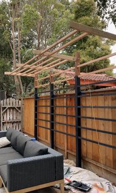 a couch sitting on top of a wooden floor next to a fenced in area