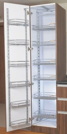 an empty refrigerator in a kitchen next to a counter top with some shelves on it