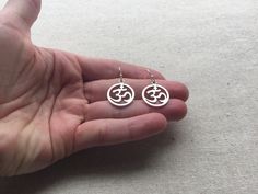 "Stunning silver Ohm round earrings. These are the perfect accessory for any yoga, meditation lover. Bring a little namaste into your life. Made from allergy free plated silver. They measure 5/8\" across by 3/4\" long and hang from simple silver ear wire hooks. I have a matching necklace in my Etsy shop. Here is the link https://etsy.me/2VBdAv9 Thanks for stopping by! Please take a moment and visit the rest of my Etsy shop. I have many more unique and stylish jewelry to choose from. 🌸 Tiger Flo Silver Symbolic Hypoallergenic Earrings, Silver Hypoallergenic Symbolic Earrings, Metal Symbolic Hypoallergenic Earrings, Symbolic Round Earrings For Pierced Ears, Pierced Symbolic Round Earrings, Symbolic Round Pierced Earrings, Hypoallergenic Circle Earrings For Gifts, Metal Hypoallergenic Plug Earrings, Hypoallergenic Metal Plug Earrings