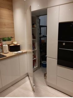 a kitchen with white cabinets and an oven