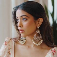 Experience the essence of India with Blossom Box's Izna Drop Earrings, a celebration of culture and craftsmanship. These earrings, bathed in luxurious gold plating and adorned with delicate pearl and polki stones, exude a unique charm that truly sets them apart. Not only are they delightfully lightweight, but they also possess the versatility to complement virtually any outfit, making them an essential addition to every jewelry collection. These earrings are a perfect embodiment of India's beaut Luxury Fusion Style Earrings, Luxury White Meenakari Bridal Earrings, Luxury Bollywood Gemstone Earrings, Luxury Bollywood Dangle Earrings, Luxury Multi-stone Temple Jewelry Earrings, Fusion Style Gold-plated Jhumkas For Wedding, Festive Pearl Drop Chandelier Earrings, Bridal Pearl Drop Earrings For Festive Celebrations, Bridal Pearl Drop Earrings For Celebrations And Festivals