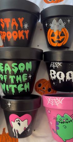 halloween planters with painted faces and words on them