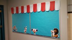 a bathroom with blue walls and red and white striped awnings