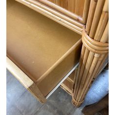 an image of a bamboo cabinet with drawers and doors open on the bottom shelf in front of it