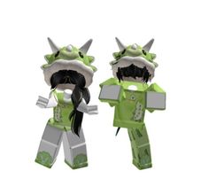 two green and white paper dolls with horns on their heads