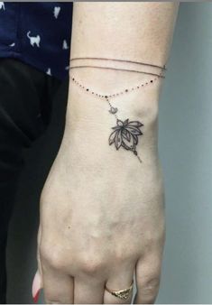 a woman's hand with a small tattoo on it