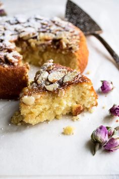 a piece of cake on a white plate with purple flowers