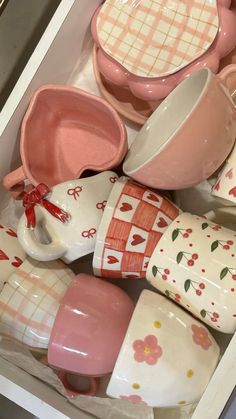 pink and white dishes, cups and spoons in a drawer