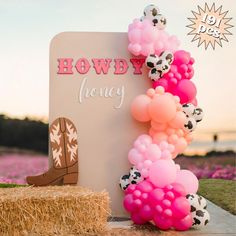 there is a sign that says hodwy honey with balloons and cow boots on it