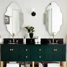 a bathroom with two sinks and mirrors on the wall