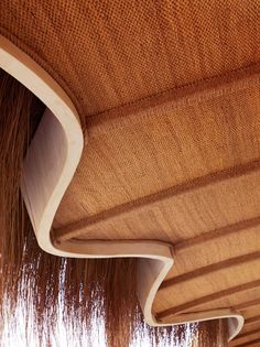 the underside of a wooden structure with long hair