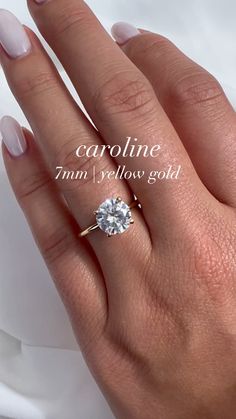 a woman's hand with a diamond ring on her finger and the words caroline written below it