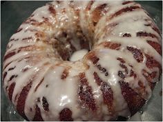 a glazed donut sitting on top of a pan covered in glaze and icing