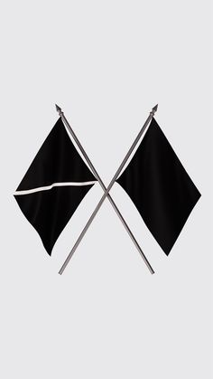 two crossed flags with one black and the other white, on a gray background that appears to be folded in half