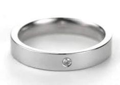 a white gold wedding ring with a diamond