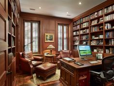 a home office with lots of bookshelves and leather chairs