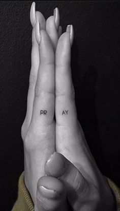 two people holding their hands up with the words pray on them