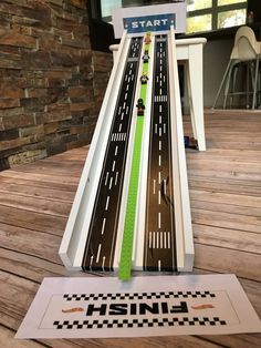 a toy car track with cars going down it