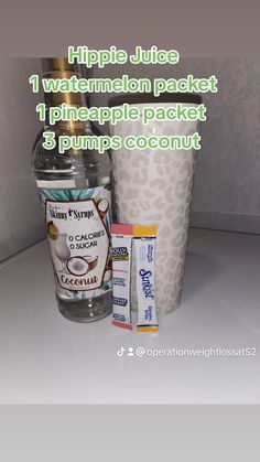 a bottle of water next to some other items on a counter with the words hippie juice 1 watermelon packet, pineapple packet and 3 pumps coconut