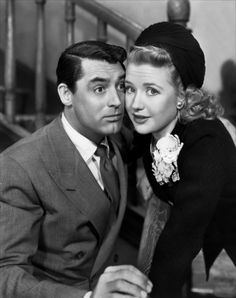 a man and woman are posing for a photo together in black and white, one is wearing a turban