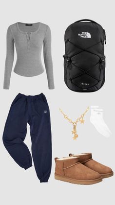 the north face sweater, pants, and boots are arranged on a gray background with gold accessories