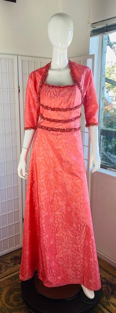 a mannequin is dressed in an orange dress