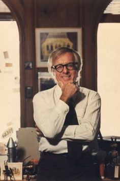 an older woman wearing glasses and a tie standing in front of a desk