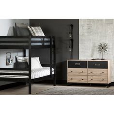 two bunk beds and a dresser in a room with black walls, white rugs and wooden flooring