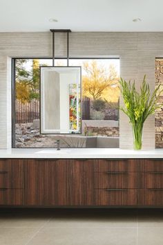 a bathroom with two sinks and a large mirror on the wall next to a window