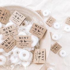 small white doughnuts are in a bowl with labels on them that say mintt to be